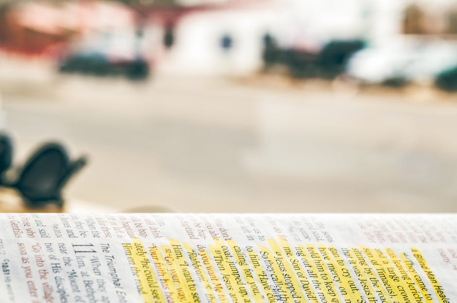 Close-up of an open Bible with highlighted text, blurred background for copyspace.